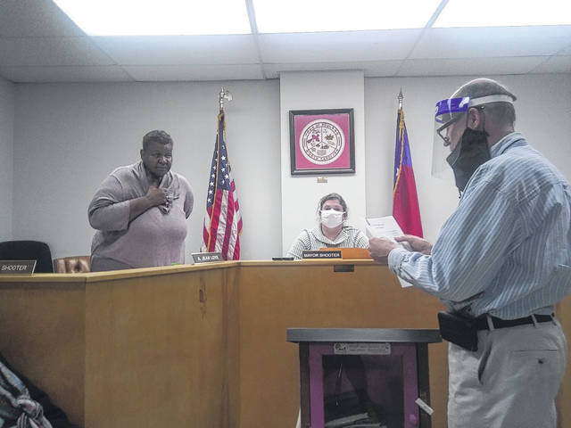 
			
				                                Rowland Town Attorney Rob Price swears in Commissioner Jean Love to the position of mayor pro tem Tuesday at the Board of Commissioners meeting. The position was left vacant by Marvin Shooter, who passed away in October.
                                 Tomeka Sinclair | The Robesonian

			
		