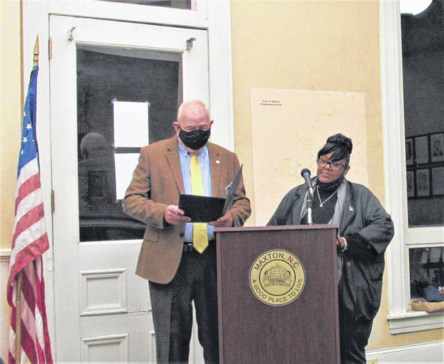 
			
				                                Maxton Mayor Paul Davis read and presented Jacqueline Johnson a resolution thanking her for nearly 25 years of service to the town. Johnson retired from the town clerk position earlier this year.
                                 Tomeka Sinclair | The Robesonian

			
		