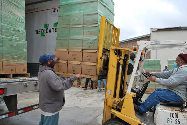 
			
				                                Lorenzo Wilson, left, and Larry Thompson, unload some of the 1,400 boxed meals from Mountaire Farms that were delivered Monday to the Lumberton Housing Authority to be distributed to needy families across the county.
 
			
		