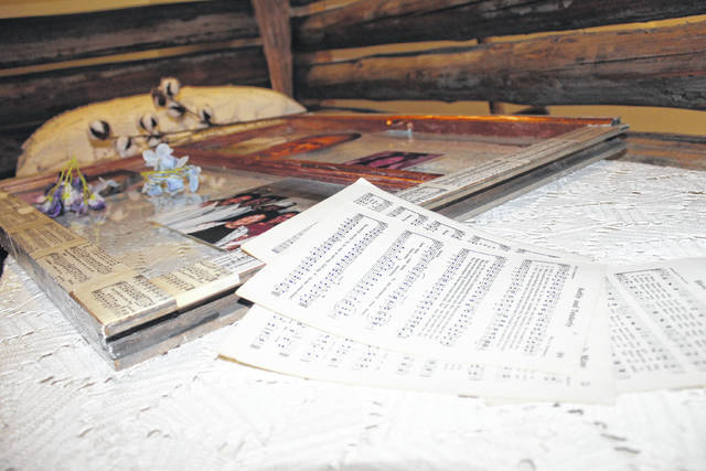 <p>Pages from a choir hymn book used by Alisha Monroe’s grandmother will line the window artworks. The pages will represent the importance of religion and music in Monroe’s family.</p> <p>Tomeka Sinclair | The Robesonian</p>