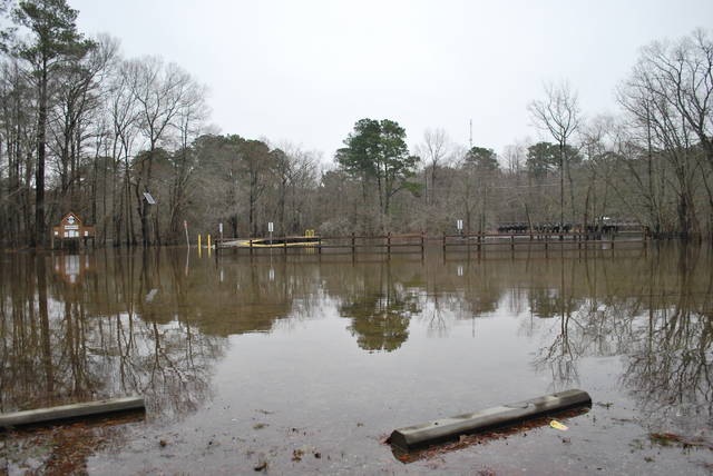 
			
				                                Water from the Lumber River covers the parking area at the N.C. 72 Lumber River boating access in Lumberton. The Lumber River, with a flood stage of 13 feet, had reached a depth of 17.8 feet Monday afternoon.
 
			
		