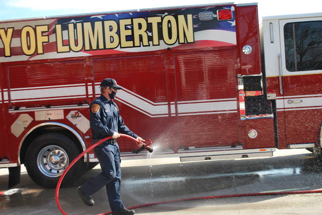 
			
				                                Master Firefighter Anthony Coleman washes down the fire department’s new Engine One pumper truck on Friday during a dedication ceremony at Lumberton Fire Department’s Central Fire Station.
 
			
		