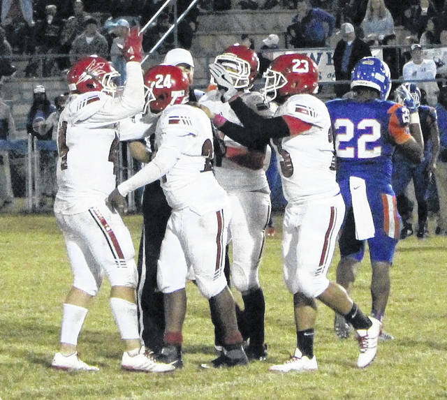 
			
				                                The Robesonian file photo
                                The Red Springs football team celebrates after a defensive score by Tony Locklear, 24, during the Red Devils’ game at Whiteville in 2019.
 
			
		