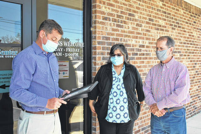 
			
				                                Stephen McIntyre, left, Human Resources chairman of the Rape Crisis Center of Robeson County’s board of directors, reads a proclamation Tuesday by Lumberton Mayor Bruce Davis designating April as Sexual Assault Awareness Month and recognizing the Center for its efforts to serve survivors. Also shown are Center Executive Director Virginia Locklear and Davis.
 
			
		