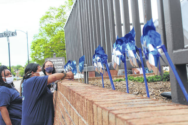 
			
				                                Robeson County Courthouse staff and other county officials planted pinwheels Tuesday in honor of National Child Abuse Prevention Month, which runs through the month April. The pinwheels and a banner can now be seen by motorists who drive by the courthouse in Lumberton.
                                 Tomeka Sinclair | The Robesonian

			
		