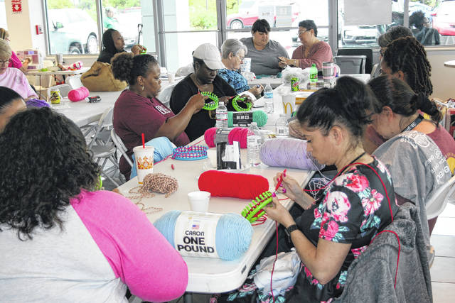 
			
				                                People who volunteered for the United Way’s 2019 Day of Caring knit hats and burp cloths for newborns and cancer patients at Lumberton Chevrolet Buick GMC Cadillac. The 2021 event is scheduled for 10 a.m. to 3 p.m. May 7.
                                 The Robesonian file photo

			
		