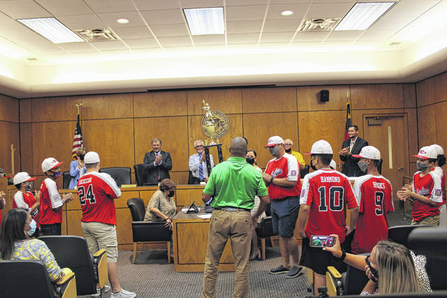 
			
				                                Eric Freeman, coach of the West Robeson Baseball Association’s Majors All-Star team, age 10-12, gives the Pembroke Recreation Department their championship trophy during a Town Council meeting held Monday. The team recently qualified for the Dixie Youth Baseball World Series, which begins Friday in Laurel, Mississippi.
                                 Tomeka Sinclair | The Robesonian

			
		