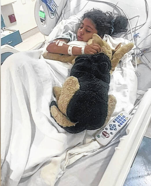 
			
				                                Estrella Sosa, 9, lies in a bed at UNC Hospital after being shot at least three times Saturday while riding with her mother in a vehicle near Pembroke.
                                 Courtesy photo

			
		
