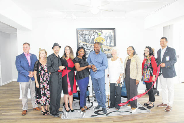 
			
				                                Fellow artists, city and county officials and family join Melvin Morris in cutting the ribbon Friday of the Inner Peace Center for the Arts in downtown Lumberton. Located at 302 N. Chestnut St, Inner Peace once housed the Kimbrell’s Furniture store.
 
			
		