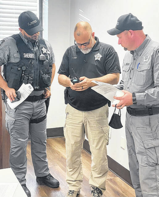 
			
				                                Robeson County sheriff’s Sgt. Levi Bass, left, Sgt. Timmy Ivey and Deputy Mike Vause work Thursday with a new VIPER radio purchased by the Robeson County Sheriff’s Office.
                                 Courtesy photo | Robeson County Sheriff Burnis Wilkins

			
		