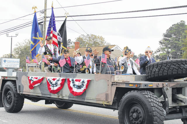 
			
				                                Tomeka Sinclair | The Robesonian
                                The Veterans of Foreign Wars Post 2843 wave to the crowd during the Veterans Day Parade held Thursday in Pembroke. Hundreds flooded sidewalks for the parade which took a two-year hiatus forced by the COVID-19 pandemic.
 
			
		