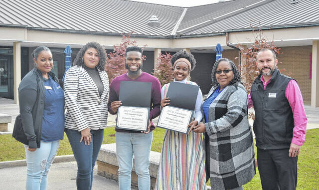 
			
				                                Decarius McKeithan and Michaela Gayle Mickles show their scholarship certificates from the State Employees Credit Union, joined by members of the Robeson Community College Foundation, Financial Aid Offices and RCC Foundation, Zilma Lopes, Jessica Bullard, Deborah Kauba, and Adam Hardin.
 
			
		