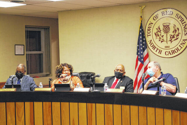 
			
				                                Elma Patterson, second from left, speaks Tuesday during a Red Springs Board of Commissioners meeting before the swearing in of recently elected board members including Ronnie Patterson who took her place on the board.
 
			
		