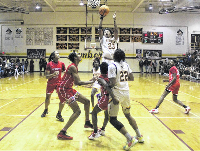 <p>Lumberton’s Angel Bowie (23) emerges from a crowded lane to take a shot during Friday’s game against Seventy-First in Lumberton.</p>
                                 <p>Chris Stiles | The Robesonian</p>
