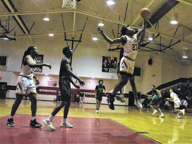 <p>Lumberton’s Angel Bowie (23) reaches up to secure a rebound during Saturday’s game against Richmond at the MLK Classic in Red Springs.</p>
                                 <p>Chris Stiles | The Robesonian</p>