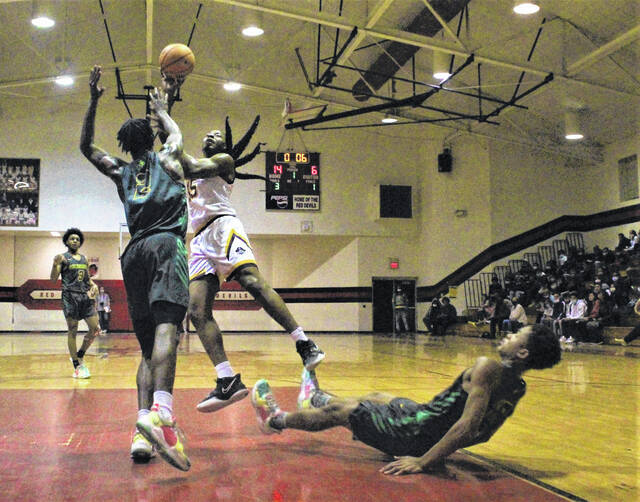 <p>Lumberton’s Tre Lewis (15) takes a shot over Richmond’s Paul McNeil (2) as Richmond’s Zion Baldwin (10) draws a charge during Saturday’s game at the MLK Classic in Red Springs.</p>
                                 <p>Chris Stiles | The Robesonian</p>