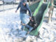 Nichlas Ivey, 2, slides with the help of his father, Colin Ivey, while playing in the snow Saturday on Linkhaw Road in Lumberton.
                                 Chris Stiles | The Robesonian