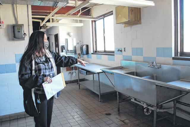 
			
				                                Jennifer Hanna, director of Early Childhood at Public Schools of Robeson County, points Monday to the kitchen area at Shining Stars Preschool in Lumberton. The area will be renovated and upgraded to serve more students as part of a $1 million expansion project.
                                 Jessica Horne | The Robesonian

			
		