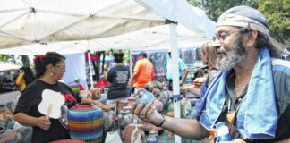 
			
				                                Lynn Paulk examines pottery during the 2019 Lumbee Homecoming. As part of this year’s Homecoming, organizers have planned a Fourth of July Summer Jam Concert 6-11 p.m. on June 30 at the Milton R. Hunt Memorial Park.
                                 Jessica Horne | The Robesonian

			
		