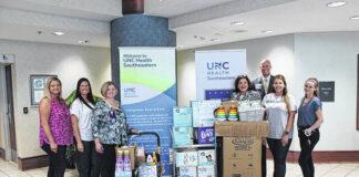 
			
				                                The Robeson-Lumberton Kiwanis Young Professionals present a generous donation to UNC Health Southeastern’s NICU, Mother/Baby and Pediatric units on Tuesday, June 28. Shown during the presentation of the gift Tuesday at the donation delivery are, from left, Kiwanis Young Professionals Chair Erika Nolley, UNC Health Southeastern Maternal/Child Health Manager Lyndsey Walters, UNC Health Southeastern NICU/Peds Manager Candy Watson, UNC Health Southeastern Foundation Executive Director Sissy Grantham, UNC Health Southeastern President/CEO Chris Ellington, and Kiwanis Young Professionals members Elizabeth Fogleman and Chasity Skusa. Kiwanis Young Professionals is made up of 12 members and is a part of Kiwanis of Robeson Lumberton, a service organization focused on improving the lives of children. Kiwanis Young Professional members held a Paint with Purpose fundraiser in May at the Inner Peace for the Arts in downtown Lumberton with local artist Brianna Goodwin. Funds raised at the event enabled members to buy items for the UNC Health Southeastern donation. Among those items were a car seat, Pack N Play, clothes, blankets, formula, toys, baby wash, lotion, wipes, diapers, and gas cards. Diapers were donated by Robeson County Church and Community Center and gas cards were donated by Oliver Oil Company.
                                 Courtesy photo | UNC Health Southeastern

			
		
