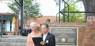 
			
				                                Lumberton Mayor Bruce Davis reads a proclamation Thursday dedicating the plaza in downtown Lumberton to the late Dick Taylor. The proclamation was presented to Taylor’s wife Lenore, also shown.
 
			
		