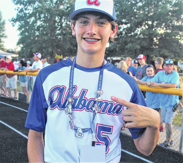 <p>Patton Mitchell from the Alabama “O”Zone team shows off the pins gifted by participants from other states during the Dixie Youth World Series opening ceremony Friday at Alton G. Brooks Stadium in Lumberton.</p>
                                 <p>Chris Stiles | The Robesonian</p>