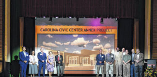 
			
				                                Shown are officials who contributed to bringing the Carolina Civic Center Historic Theater Annex project to fruition. From left are Rep. Charles Graham; Andrea Nicole Royster of the Truist Foundation; and C. Philip Stone of Truist Bank; Angela Sumner, Lumberton Tourism; Mayor Bruce Davis, Brandon Love, and Wayne Horne of the City of Lumberton; John Dunlap, LTDA Board member; Sen. Danny Britt; Lumberton Attorney Holt Moore; and Richard Sceiford and Dennis Watts, of the Carolina Civic Center Foundation.
 
			
		
