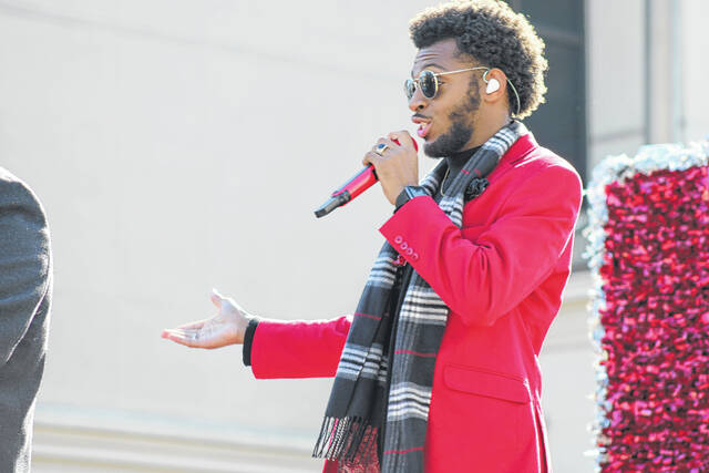 <p>DJ Brown performs aboard the Chic-fil-A float at the Lumberton Christmas Parade which kicked off the parade season.</p>
                                 <p>Tomeka Sinclair | The Robesonian</p>