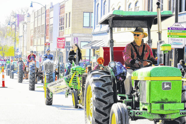 <p>A line of tractors travels down Elm Street in Lumberton for the annual Christmas parade held by the Lumberton Area Chamber of Commerce.</p>
                                 <p>Tomeka Sinclair | The Robesonian</p>