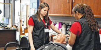 
			
				                                Hannah Davis, left, assists another cosmetology student with a client at Robeson Community College.
                                 Courtesy photo | Robeson Community College

			
		