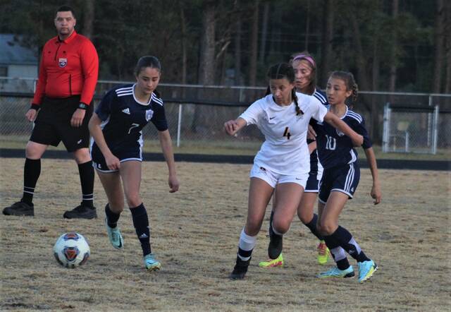 <p>Lumberton’s Aydan Bullard (4) and Purnell Swett’s Ava Giles (7) and Aonor Woodell (10) battle for possession during Saturday’s Robeson Cup championship match in Pembroke.</p>
                                 <p>Chris Stiles | The Robesonian</p>
