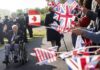 
			
				                                People wave flags for World War II veterans before a ceremony at the Pegasus Bridge memorial in Benouville, Normandy, Monday June 5, 2023. In 1944 seventeen year old Marie Scott worked on the switchboard in Fort Southwick, and transmitted messages to and from the beaches. Dozens of World War II veterans have traveled to Normandy this week to mark the 79th anniversary of D-Day, the decisive but deadly assault that led to the liberation of France and Western Europe from Nazi control. (AP Photo/Thomas Padilla)
 
			
		