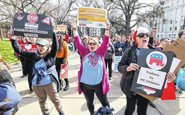 From left, Sarah Juhl of Weddington and Jenn of Waxhaw cheer on speakers at a rally for education funding on the grounds of the North Carolina State Capitol on Thursday, February 22, 2024 in Raleigh, North Carolina. -Sanders, Meg Bell of Monroe. The case comes as the state Supreme Court is hearing oral arguments in the long-running Leandro school funding case.Ethan Hyman | News and Observer via AP