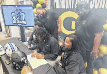 
			
				                                Fairmont’s Dontrel Hughlon, center, signs to play college football at Virginia University Lynchburg during a ceremony Thursday in Fairmont. He is pictured with his family and Fairmont coaches.
                                 Contributed photo

			
		
