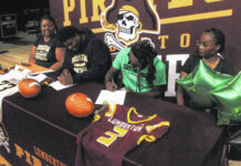 
			
				                                Lumberton’s Kendrick Tyson, center left, signs to play football at North Carolina Wesleyan, while Travon Moore, center right, signs to Greensboro College during a ceremony Tuesday in Lumberton.
                                 Chris Stiles | The Robesonian

			
		