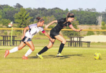 
			
				                                Purnell Swett’s Josie McLean (6) and Lumberton’s Chloe Hammonds (22) chase after the ball during Friday’s match in Lumberton.
                                 Chris Stiles | The Robesonian

			
		