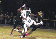 
			
				                                Lumberton’s Michael Pitts (6) and a Pirates teammate and Purnell Swett’s Jedidiah Wilkins (11) and Lakoda Locklear (18) fight for every inch as a pass approaches during an Oct. 27, 2023, game in Lumberton.
                                 Chris Stiles | The Robesonian

			
		