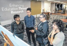 
			
				                                REACH Fellow Ahe Oxouzidis (second from left) discusses his ongoing ‘Reclaiming Lumbee Identity’ research project with REACH Fellow Unmai Arokiasamy and Drs. Mary Ann Jacobs and Michele Fazio.
                                 Contributed photo | UNCP

			
		