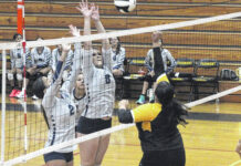 
			
				                                Purnell Swett’s Riley Deese (8) and Harley Barfield (2) attempt to block the spike of Fairmont’s Alexis Brown, right, during Wednesday’s match in Fairmont.
 
			
		